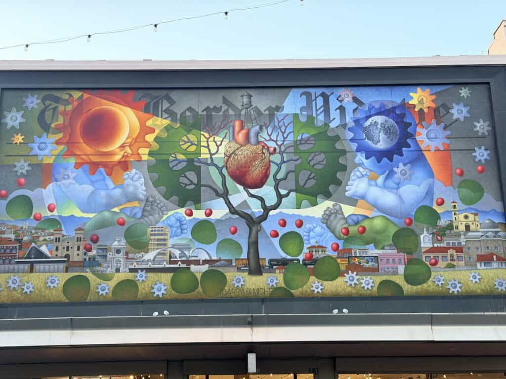 Painting illustrating Nogales as two different realities divided by the border